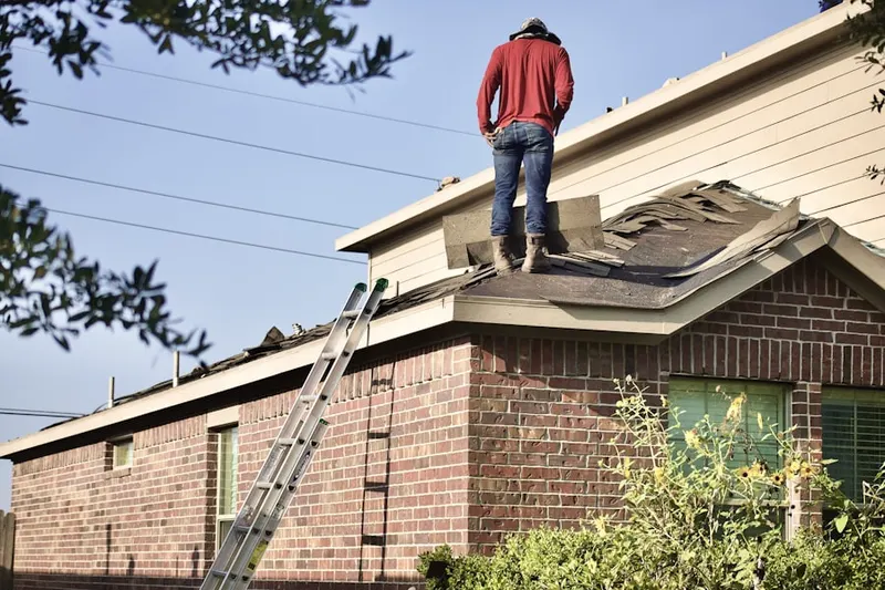 Professional roofer working on a residential roof in Poinsettia